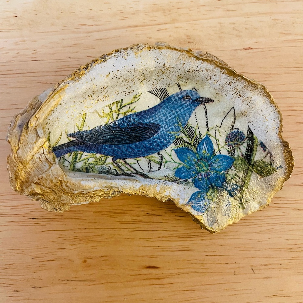Custom blue bird with flowers decoupaged on oyster shell. Jewelry/trinket dish.